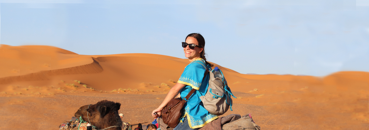 A Cabrini student on a camel during a study abroad trip