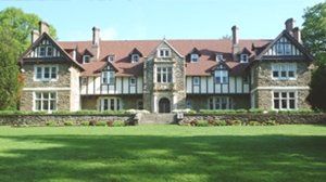 The Mansion at Cabrini with a large yard in front