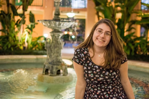 Student in front of a fountain