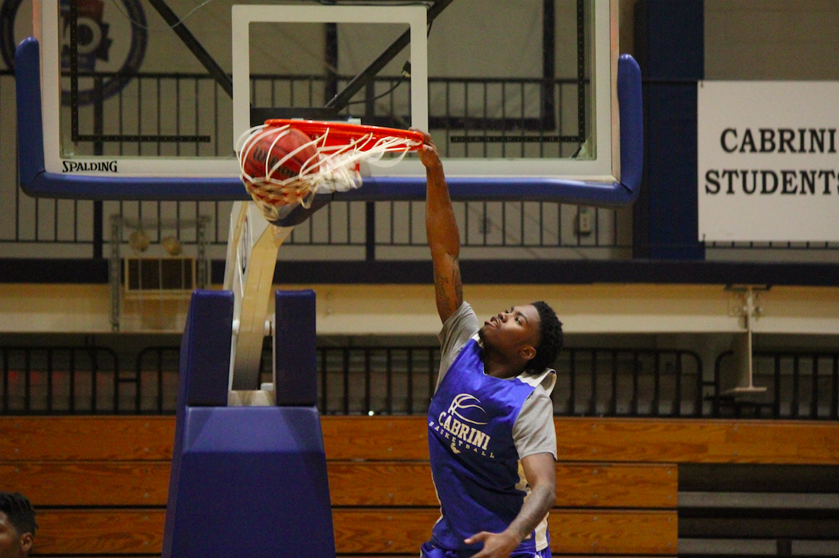 Cabrini student dunking a basketball