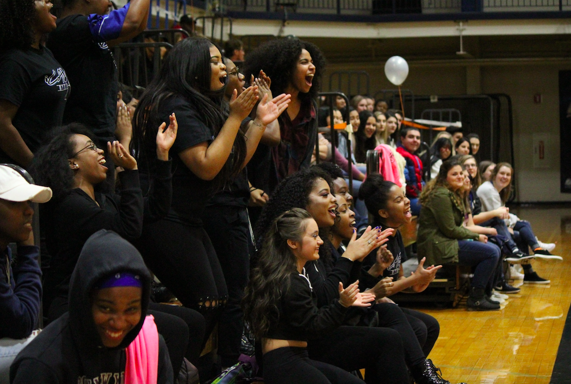 Students cheering in the bleachers 
