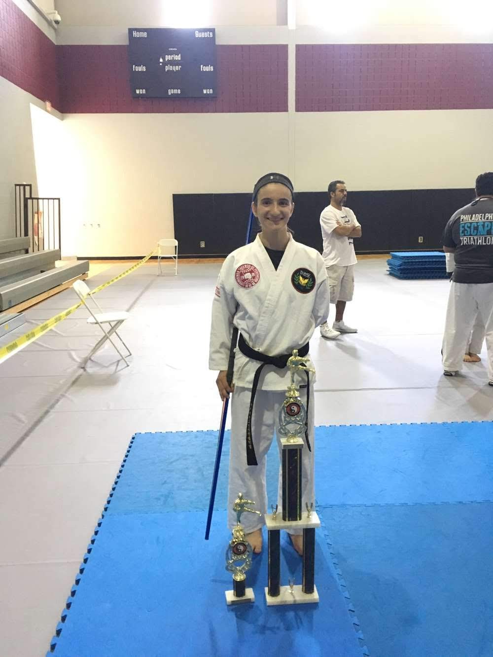 Maria Lattanze at a karate tournament taking home first place in weapons and third place in forms