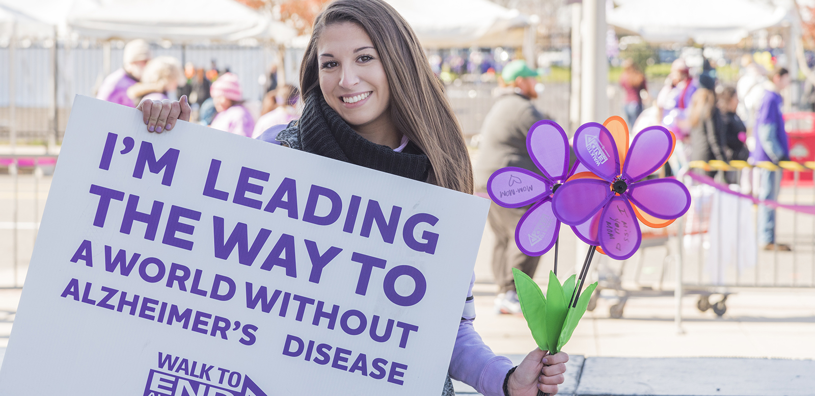 Emily holding poster at the Walk To end Alzheimer's 