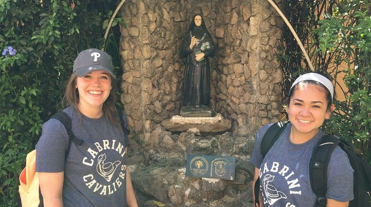 Molly and Emily pose with Mother Cabrini Statue 