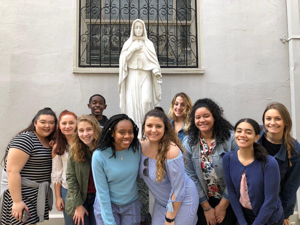 students in front of Mother Cabrini statue 